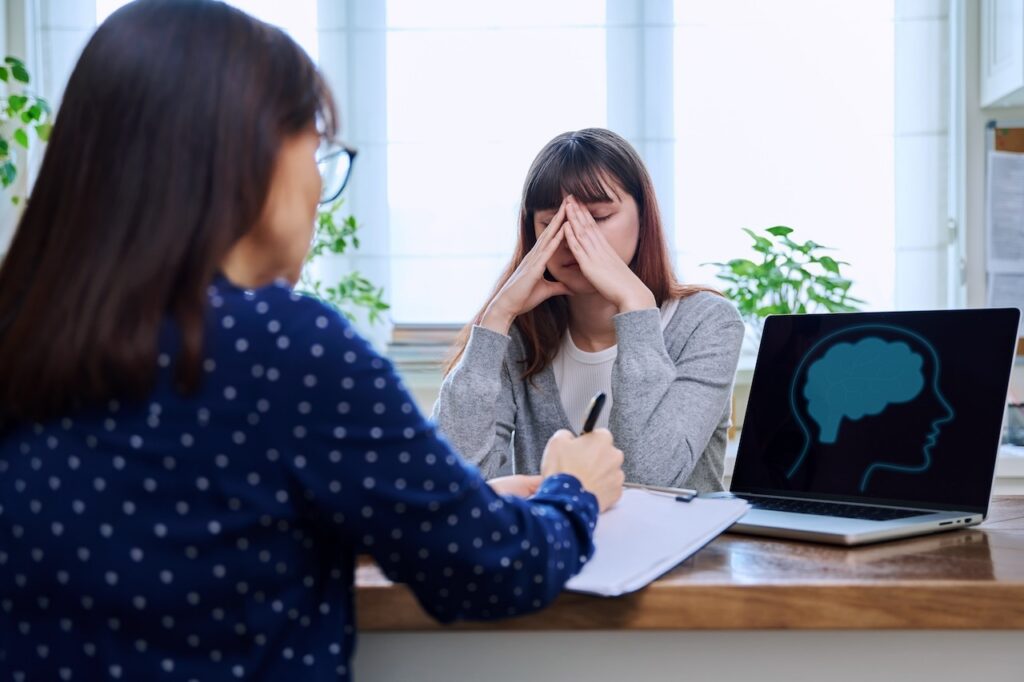 sad teenage girl receiving mental health diagnosis